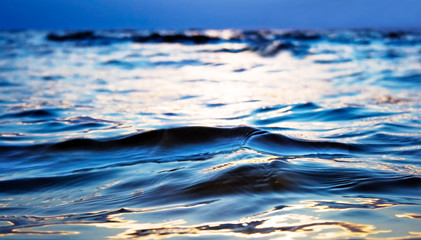 Turquoise transparent wave of Baltc sea on sunset