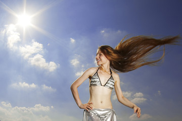 Girl with long hair against the sky