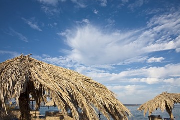 Fototapeta na wymiar Palm leaves umbrella on an exotic beach in Egypt