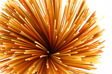 Raw colorful spaghetti in close up from above