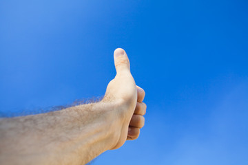 Hand against the blue sky