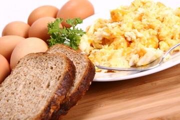 Scrambled eggs, some fresh eggs and wholemeal bread