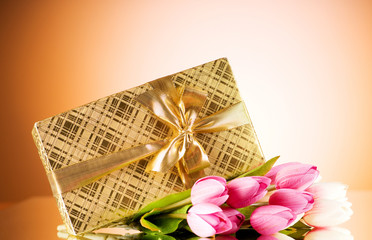 Celebration concept - gift box and tulip flowers