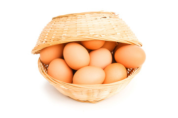 Brown eggs in the basket on white
