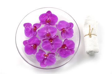 Bowl of orchid and white towel