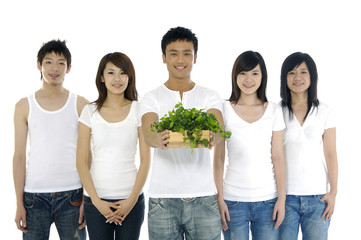 group of friends and young man holding small potted