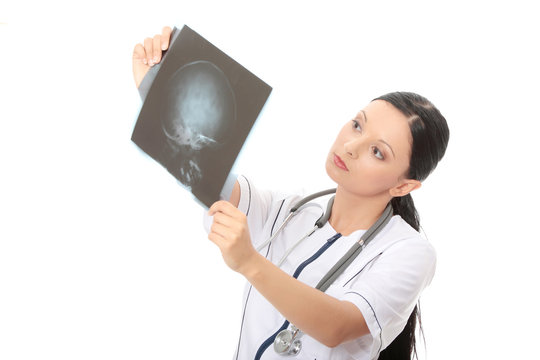 Thoughtful female doctor looking at the x-ray image