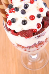 Whipped cream with raspberries, red currants and blue berries