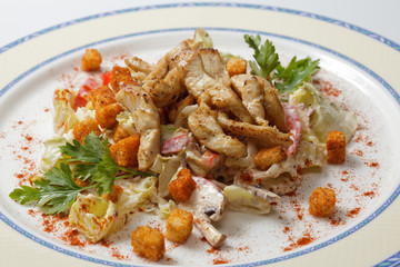 Chicken salad with crackers on a white plate