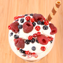 Whipped cream with raspberries, red currants and blue berries