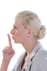 Woman with finger to mouth gesturing for quiet