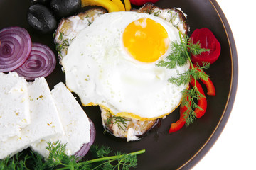 egg on dark plate with vegetables