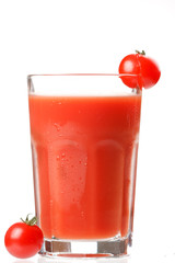 Fresh tomatoes and a glass full of tomato juice