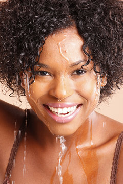 Cute African American with water dripping through her face