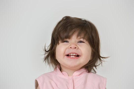 smiling child in a pink jacket