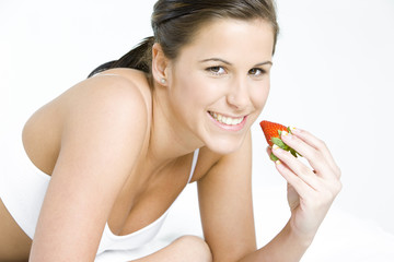 portrait of lying down woman with a strawberry