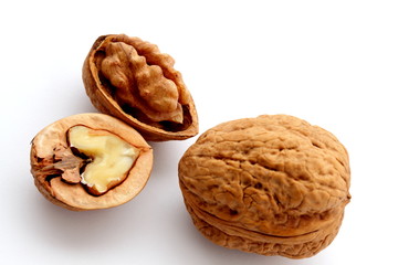 Group of  few ripe walnuts on white background