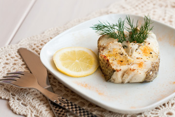 Baked cad served with lemon and dill