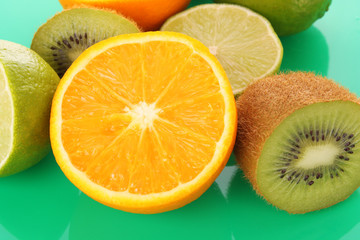 Fototapeta na wymiar Orange and other fruits on green