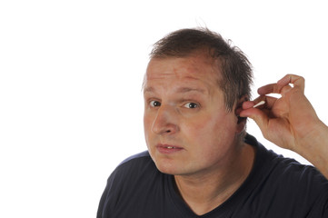 Man cleans his ears. - 24584962