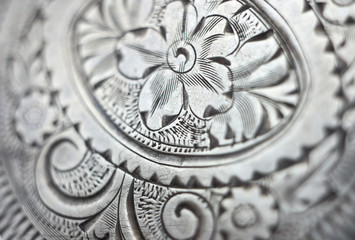 Antique silver engraving background closeup.