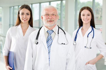 Fototapeta premium A portrait of doctor with two attractive nurses