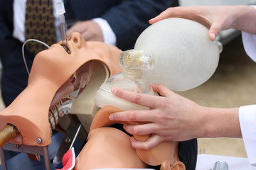The man on a dummy trains to do Cardiopulmonary resuscitation