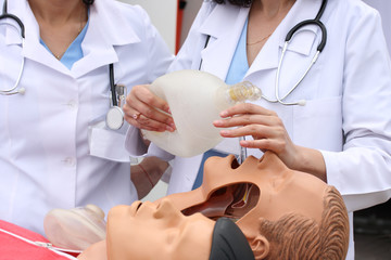 The man on a dummy trains to do Cardiopulmonary resuscitation