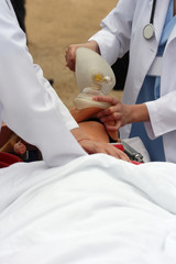 The man on a dummy trains to do Cardiopulmonary resuscitation