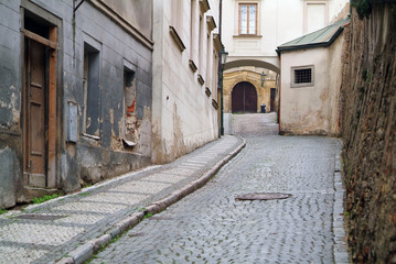 Fototapeta na wymiar Narrow alley between tenement houses in Prague.
