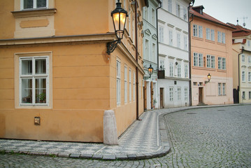 Naklejka premium Narrow alley between tenement houses in Prague