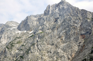 Grey mountain peak with little snow