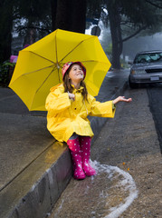 Young girl playing in rain
