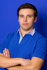 portrait of young casual man, on a blue background