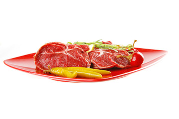 raw meat chunk on red plate