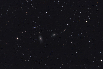 Galaxy Trio in Draco constellation with stars background.