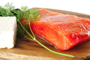 fresh smoked salmon on white plate with white cheese