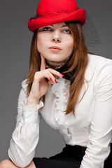 Portrait of a pretty young woman with red bonnet