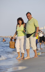 happy seniors couple  on beach