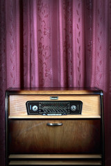 Old vintage radio on red background