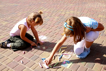 two little girls painted on the pavement - obrazy, fototapety, plakaty