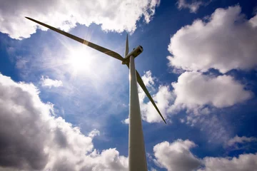 Cercles muraux Moulins Wind turbine over a cloud filled blue sky, alternative energy so