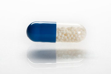 close-up of blue medical capsule isolated on white