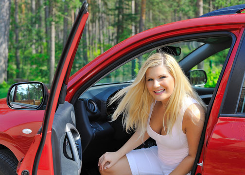 Beautiful Woman Driver In Red Shiny Car Opens The Door