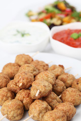 Roast meatballs with tzatziki and tomato dip and salad