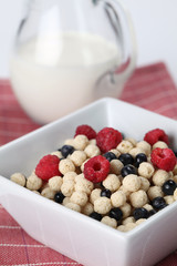 Vanilla cereals with raspberries and blueberries. Shallow DOF