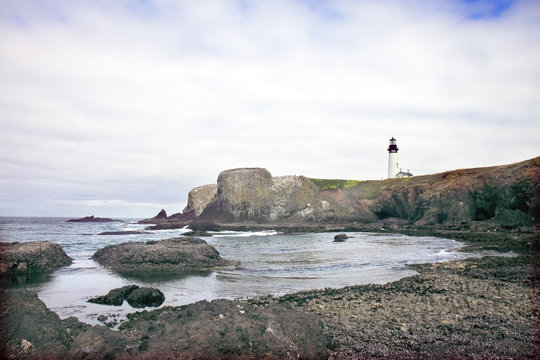 Lighthouse over Rocky Shore
