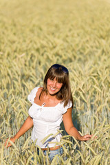 Happy woman in corn field enjoy sunset