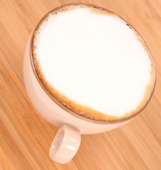 Cup of coffee latte on a wooden background