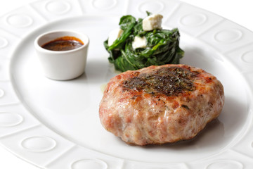 meat and sause on a white plate